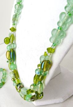 Lovely shades of minty green, khaki, peppermint green, sea foam green & more! This jewelry set is inspired by nature, specifically from the light green glass butterfly beads. A 2-layer beaded necklace from glass, foil, acrylic, czech glass, semi-precious stones & seed beads of different shapes & sizes. There are even leaf shaped beads to give the feeling of the butterflies in a garden. The necklace measures about 22.5 inches in length, with a 2 inch extension. There are 2 bracelets to match the necklace, both on clear strong elastic. Wear both bracelets together, or only 1 at a time! A perfect style of accessory for upcoming spring! Layered Beaded Necklaces, Minty Green, Glass Butterfly, Green Butterfly, Black Necklace, Leaf Shapes, Stone Jewelry, Light Green, Jewelry Set