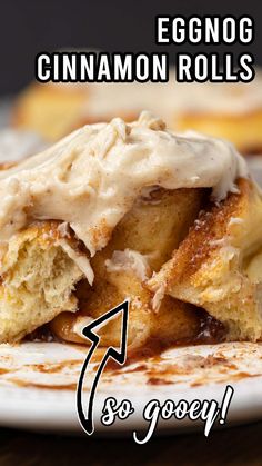 an eggnog cinnamon roll is on a plate with the words, to gooey