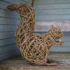 a sculpture of a squirrel made out of twigs