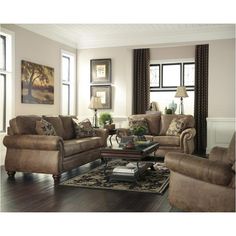 a living room with couches, chairs and a coffee table in front of two windows