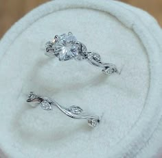 two engagement rings sitting on top of a white towel