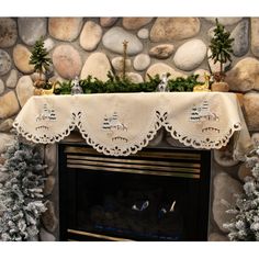 a fireplace with a mantle covered in christmas decorations