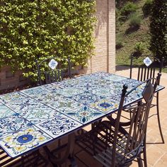 an outdoor table and chairs are set up outside