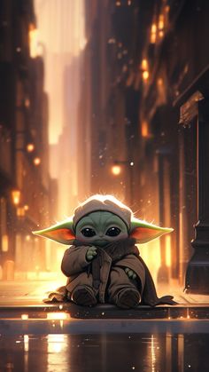 a baby yoda sitting on the ground in front of a city street at night