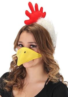 a woman wearing a red and white chicken mask with horns on it's head