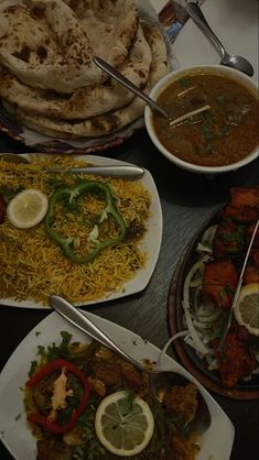 several plates of food are arranged on a table