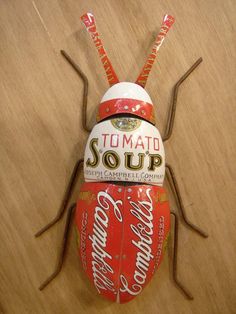 a close up of a toy insect on a wooden surface with words written in it