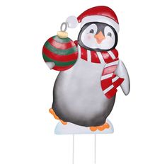 a penguin is holding a christmas ornament