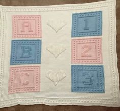 a crocheted blanket with squares and hearts on it