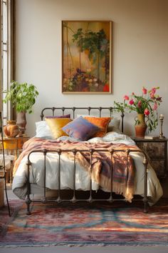 a bed sitting in a bedroom next to a window with potted plants on top of it