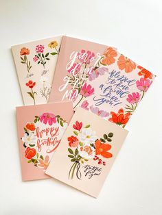 four greeting cards with flowers and the words happy birthday written in cursive writing