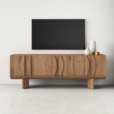 an empty room with a wooden cabinet, vases and a blackboard on the wall