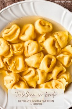 tortellini in broccoli is served on a white plate