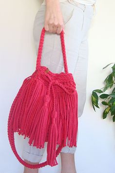 Hand crochet to order crossbody boho bag. Made with strong and durable, but soft cotton rope with fringes around. Choose your favourite color for the bag and lining with two deep pockets! Summer Bohemian Pink Bucket Bag, Spring Bohemian Bucket Bag With Braided Handles, Pink Bohemian Bucket Bag, Summer Bucket Bag With Tassels, Bohemian Pink Bucket Bag For The Beach, Pink Bohemian Bucket Bag For The Beach, Bohemian Pink Bucket Bag For Beach, Spring Bohemian Woven Bucket Bag, Summer Festival Bucket Shoulder Bag