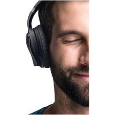 a man with his eyes closed wearing headphones