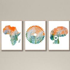 three art prints with different colors and shapes on the wall in a living room area