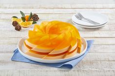 an orange cut into pieces sitting on top of a white plate