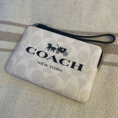 Beautiful White And Black Coach Wristlet Everyday White Bag With Wrist Strap, Chic White Wristlet For Everyday Use, Coach White Rectangular Wristlet, White Rectangular Coach Wristlet, Trendy White Pouch Wristlet, White Wristlet With Zipper Closure, White Clutch With Wrist Strap For Everyday Use, Chic White Pouch Wristlet, White Coach Pouch Wristlet