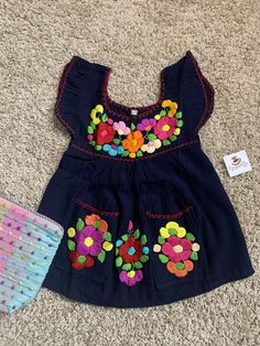 "12 months, Beautiful & Authentic Mexican Girls Dress, very fresh and light weight made with cotton blend fabric. All embroidered work is Handmade, just gorgeous and unique.... Size: 12 Months Care Details: Hand wash only, Hang dry Measurements: 17\" long 11\" waist Great for any celebrations or good for a sunny birthday party as well. Don't wait till the last minute and email me TODAY.... All of my items come from a smoke and pet free environment. Please email me your questions before buyin Blue Cotton Dress With Floral Applique, Spring Cotton Embroidered Dress With Floral Applique, Cute Embroidered Cotton Dress, Spring Cotton Embroidered Dress With Machine Embroidery, Cotton Embroidered Dress With Machine Embroidery For Spring, Spring Cotton Dress With Embroidered Border, Multicolor Cotton Embroidered Dress With Embroidered Hem, Blue Cotton Dress With Embroidered Border, Summer Cotton Dress With Machine Embroidery