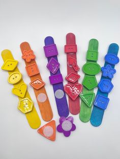 a group of colorful plastic objects sitting on top of a white table next to each other