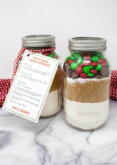 two mason jars filled with different types of candy and cookies, one has a printable tag on it