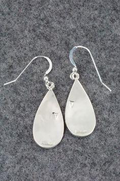 These sterling silver earrings are made by Hopi silversmith Timothy Mowa. The backs are signed and stamped sterling.Length: 1 5/8"Width: 1/2"Free shipping on all orders! We ship with USPS and always include tracking. All orders ship within a day of payment.Returns are accepted up to 30 days after you receive your order. Just send us a message. Our shop offers cash back or store credit. The item must be returned in new condition. Silver Teardrop Earrings With Polished Finish For Gift, Silver Sterling Teardrop Earrings With Polished Finish, Hallmarked Sterling Silver Teardrop Jewelry, Engraved Sterling Silver Drop Earrings, Engraved Teardrop Sterling Silver Earrings, Silver Engraved Teardrop Earrings, Collectible Sterling Silver Drop Earrings, Artisan Sterling Silver Nickel-free Teardrop Earrings, Sterling Silver Long Drop Jewelry With Polished Finish