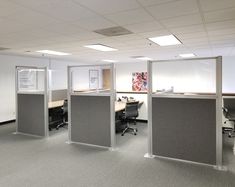 an empty office with cubicles and desks