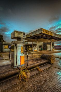 an old gas station sits empty on the ground