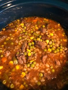 a pot filled with meat and beans in a broth