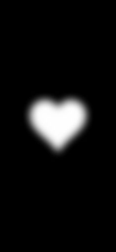 a white heart shaped object in the dark