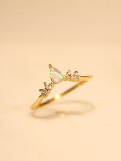 Perfect for every day, every look, and every aesthetic, the Monarch Opal Ring is the perfect piece for any ring collection! Updated with a touch of Serendipity magic with a mesmerizing yet dainty opal heart taking center stage. Understated yet eye-catching, this ring is perfect for any stacked ring look or as a stand alone stunner. 💕 …………………………………. RING SIZE & MATERIAL❋ water resistant 14k gold plated stainless steel❋ ethiopian opal❋ nickel free Delicate Adjustable Opal Ring For Promise, Elegant Adjustable Opal Stackable Rings, Dainty Opal Open Ring For Wedding, Opal Birthstone Promise Ring, Dainty Opal Stackable Rings For Anniversary, Elegant Opal Toe Ring, Elegant Adjustable Opal Crystal Ring, Adjustable Elegant Opal Crystal Ring, Elegant Teardrop Opal Promise Ring