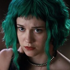 a woman with green hair wearing a choker