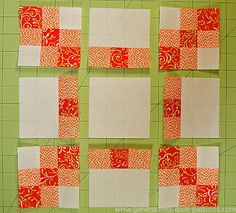 four squares are arranged on a green cutting board with white and red strips in the middle