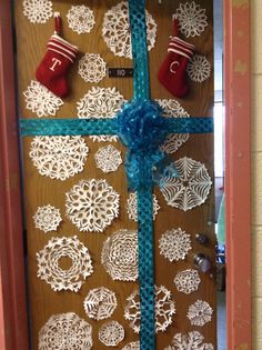 a door decorated with snowflakes and stockings