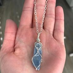 "☾ Blue Kyanite Necklace ☾ High quality, small, blue kyanite in its raw form in a secure & subtle setting that highlights the stone These pendants come in pure copper or sterling silver. Choose from an adjustable Faux leather chord (vegan friendly) or choose a matching 18\" copper chain or sterling silver chain. Faux leather chords are \"vegan friendly\" because they are actually cotton made to look like leather. These chords are also tied to be adjustable so you can wear it at your desired Blue Kyanite Necklace For Gift, Blue Mineral Crystal Necklace For Gift, Blue Raw Stone Crystal Necklace As Gift, Blue Raw Stone Crystal Necklace Gift, Blue Wire Wrapped Crystal Necklace For Healing, Sapphire Kyanite Necklace For Gifts, Sapphire Kyanite Necklace As Gift, Sapphire Color Kyanite Necklace For Gift, Blue Kyanite Jewelry