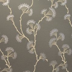 the wallpaper is grey and has white flowers on it, as well as gold trimmings