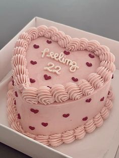 a heart shaped cake with the words feeling 22 on it's side in a box