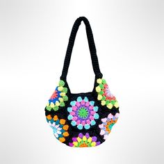 a black purse with multicolored flowers on the front and side, hanging from a string