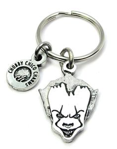 a keychain with the image of a clown on it's face and words