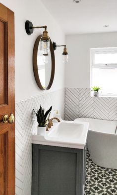 a bathroom with a sink, mirror and bathtub