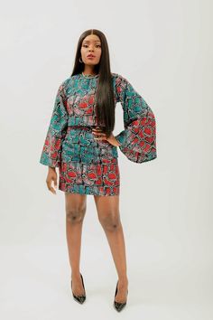 This African Print (Ankara) crop top & mini skirt set is skillfully created from light-weight cotton to offer a perfect blend of captivating charm and fragility. The top features a round neckline and long bell sleeves, while the skirt is designed with a high-waisted silhouette and back zipper. This ensemble makes it easy to enjoy a fashionable and comfortable look no matter the temperature. Set is named after the style of dance from Côte d'Ivoire; Coupé-décalé   100% Ankara wax cotton  Victoria Fitted Multicolor Mini Length Sets, Fitted Multicolor Mini-length Sets, Multicolor Fitted Mini Length Sets, Fitted Cotton Mini Crop Top, Fitted Cotton Two-piece Set, Chic Green Cotton Sets, Ankara Crop Top And Skirt, Ankara Top And Skirt, African Print Crop Top