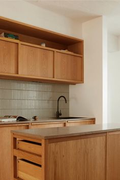 a kitchen with wooden cabinets and counter tops