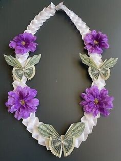 a necklace with purple flowers and butterflies on it