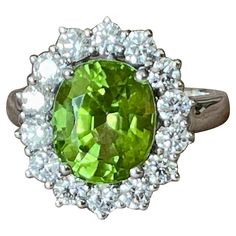 An 18 K whitel Gold Ring that contains an oval Peridot weighing 10.26 ct and 18 brilliant cut Diamonds weiging 1.61 ct. The face of the ring measures 1.9 cm tall by 1.55 cm wide. It is stamped with the makers mark and 750. The ring size is currently a swiss 53/13 American Ring size 6 1/2, but can easily be resized. Masterfully handcrafted piece! Authenticity and money back is guaranteed. For any enquires, please contact the seller through the message center. White God, Message Center, Gold Cocktail Ring, Gold Cocktail, Diamond Cocktail Rings, La Face, Peridot Ring, Brown Diamond, Oval Cut Diamond