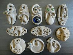 nine ceramic animal figurines are displayed on a table