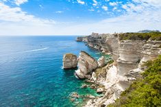 the ocean is clear and blue with cliffs on both sides that look like they're floating in the water