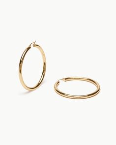 Deliver bold and gold. Our 14k yellow gold hollow Large Tube Hoops attain the look of a thick, oversized hoop without fatiguing your ears. With a substantial width of 4mm and a secure lever closure, these eye-catching hoops won’t be exiting your ears any time soon. Modern Gold-tone Hoop Earrings, Classic Hoop Jewelry With Gold-tone Hardware, Yellow Gold Hoop Earrings With Gold-tone Hardware, Luxury Gold-tone Hoop Earrings, Gold-tone Hoop Earrings, Classic Gold-tone Hoop Earrings, Yellow Gold, Yellow, Gold