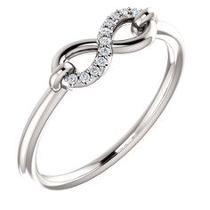 a white gold ring with diamonds in the middle and an intertwined design on top