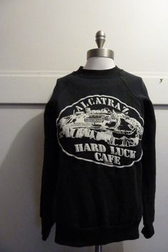 Here we have a super fun find. A vintage Hard Luck Cafe Alcatraz circa 1980s very soft baseball style sweatshirt. Its never easy to find vintage finds in smaller sizes especially older sweatshirts. With a flattering fit and a universal color scheme you are sure to be able to pair this puppy up with a pencil skirt or skinny jeans. ** International orders please contact us prior to purchase :) ** In excellent un worn condition. Tag reads size small measurements are as follows: shoulder to shoulder Old Sweatshirt, Vintage Finds, Sweater Outfits, Sweat Shirt, With Love, Pencil Skirt, Sweaters For Women, Cafe, California