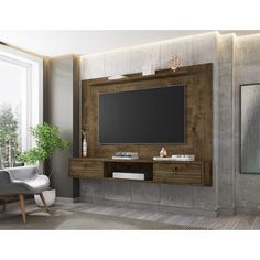 a living room with a large tv mounted on the wall